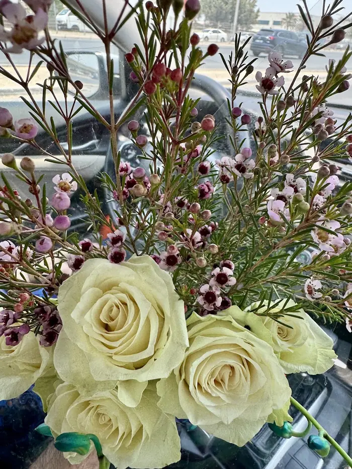 White roses with wax flower, wrapped at Reemflora